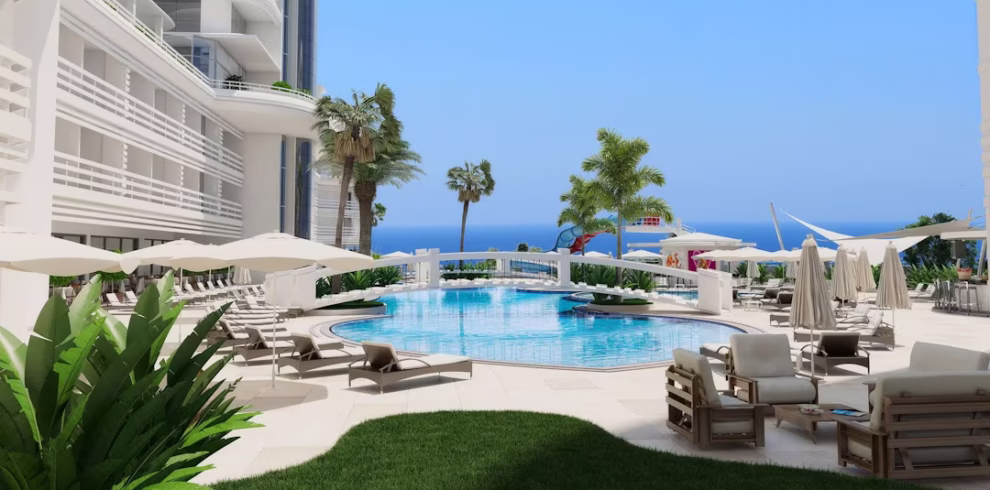 View of Laguna Beach Alya Resort with outdoor pools and the Mediterranean Sea in the background