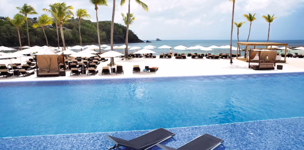 Oceanview pool at Royalton Saint Lucia with sun loungers and palm trees