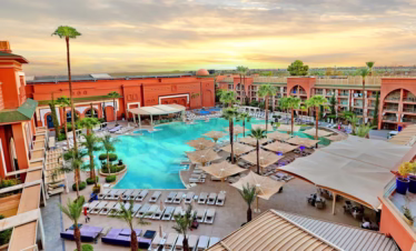 Exterior view of Savoy Le Grand Hotel Marrakech at sunset in Hivernage